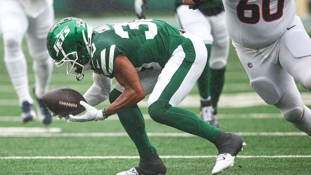 Sep 29, 2024; East Rutherford, New Jersey, USA; New York Jets cornerback Michael Carter II (30) recovers a fumbles in front of Denver Broncos center Luke Wattenberg (60) during the first half at MetLife Stadium. Mandatory Credit: Vincent Carchietta-Imagn Images