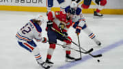 Jun 12, 2025; Sunrise, Florida, USA; Florida Panthers forward Sam Bennett (9) controls the puck against Edmonton Oilers right wing Kasperi Kapanen (42) and center Leon Draisaitl (29) during the first period in game four of the 2025 Stanley Cup Final at Amerant Bank Arena. Mandatory Credit: Jim Rassol-Imagn Images