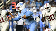 Nov 8, 2025; Chapel Hill, North Carolina, USA; North Carolina Tar Heels quarterback Gio Lopez (7) breaks a tackle as Stanford Cardinal linebacker Matt Rose (35) defends in the third quarter at Kenan Stadium. Mandatory Credit: Bob Donnan-Imagn Images