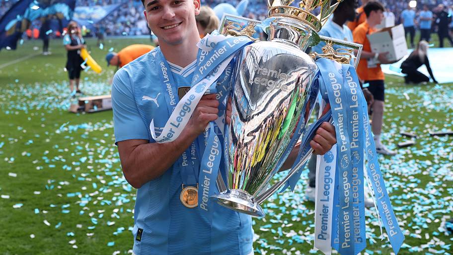 Julián Alvarez holding the Premier League trophy.