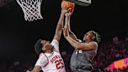 Jan 11, 2025; Athens, Georgia, USA; Oklahoma Sooners forward Jalon Moore (14) shoots over Georgia Bulldogs forward Justin Abson (25) during the second half at Stegeman Coliseum. Mandatory Credit: Dale Zanine-Imagn Images