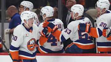 Mar 18, 2025; Pittsburgh, Pennsylvania, USA;  New York Islanders right wing Simon Holmstrom (10) celebrates his empty net goal with the New York bench against the Pittsburgh Penguins during the third period at PPG Paints Arena. Mandatory Credit: Charles LeClaire-Imagn Images