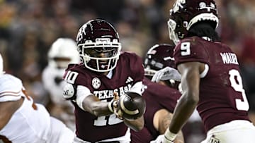 Nov 30, 2024; College Station, Texas, USA; Texas A&M Aggies quarterback Marcel Reed (10) hands off the ball to wide receiver Jahdae Walker (9) during the first half against the Texas Longhorns at Kyle Field. Mandatory Credit: Maria Lysaker-Imagn Images 
