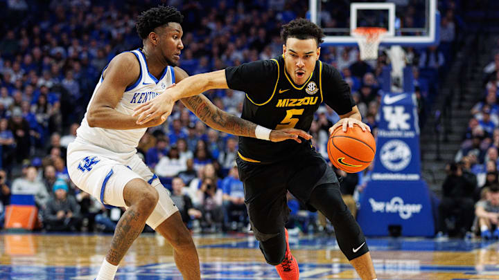 Jan 9, 2024; Lexington, Kentucky, USA; Missouri Tigers guard John Tonje (5) drives to the basket against Kentucky Wildcats guard Justin Edwards (1) during the first half at Rupp Arena at Central Bank Center. Mandatory Credit: Jordan Prather-Imagn Images