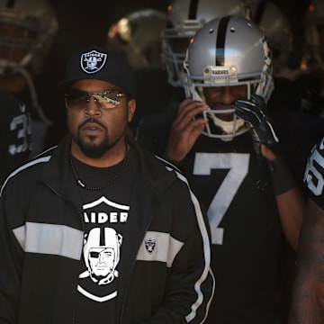 Oct 19, 2014; Oakland, CA, USA; Recording artist and entertainer Ice Cube leads Oakland Raiders players onto the field before the game against the Arizona Cardinals at O.co Coliseum. Mandatory Credit: Kirby Lee-Imagn Images

