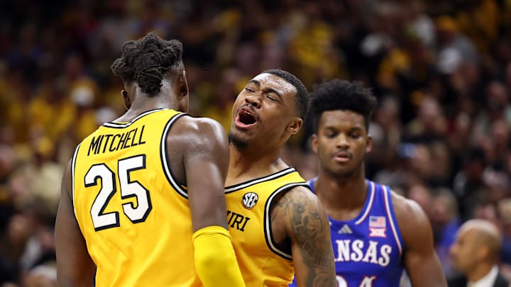 Missouri Tigers plays Tony Perkins (12), and Mark Mitchell (25) celebrate after a basket in a game against the Kansas Jayhawks this season.