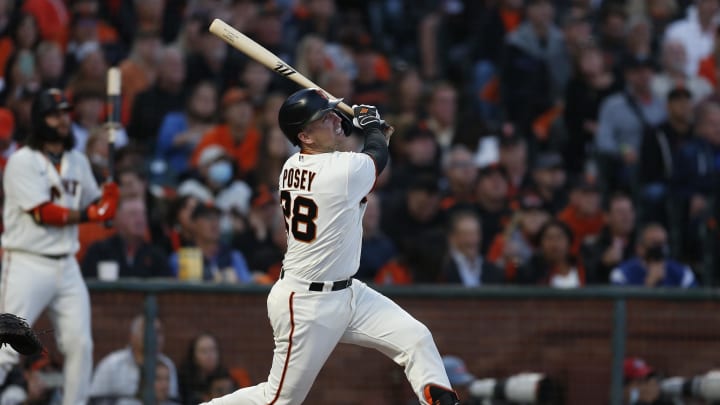 San Francisco Giants catcher Buster Posey (28) hits a double against the Los Angeles Dodgers in the first inning during game five of the 2021 NLDS at Oracle Park in 2021.