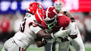 Dec 6, 2025; Atlanta, GA, USA; Alabama Crimson Tide wide receiver Germie Bernard (5) makes a catch as Georgia Bulldogs linebacker Quintavius Johnson (33) tackles during the fourth quarter during the 2025 SEC Championship game at Mercedes-Benz Stadium. Mandatory Credit: Brett Davis-Imagn Images