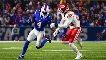 Nov 17, 2024; Orchard Park, New York, USA; Buffalo Bills running back James Cook (4) runs with the ball against Kansas City Chiefs safety Justin Reid (20) during the first half at Highmark Stadium.