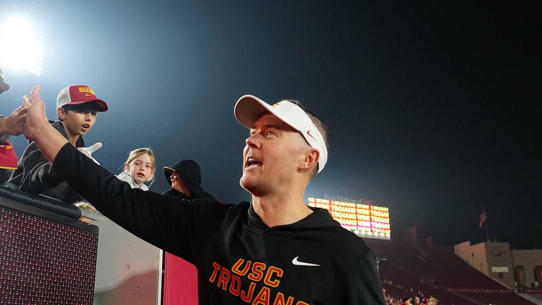 Southern California Trojans head coach Lincoln Riley celebrates with fans after the game against the UCLA Bruins at United Airlines Field at Los Angeles Memorial Coliseum.