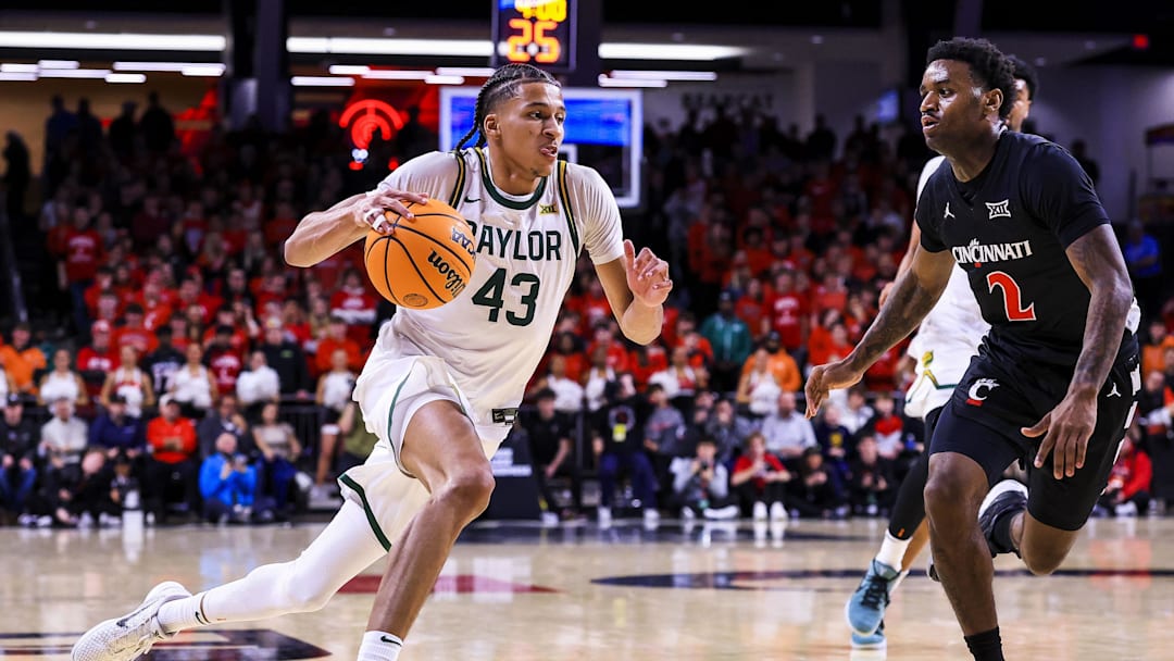 Jan 28, 2026; Cincinnati, Ohio, USA; Baylor Bears guard Cameron Carr (43) dribbles against Cincinnati Bearcats guard Jizzle James (2) in the second half at Fifth Third Arena. Mandatory Credit: Katie Stratman-Imagn Images