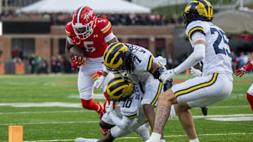 Nov 22, 2025; College Park, Maryland, USA;  Michigan Wolverines defensive back TJ Metcalf (7) and defensive back Zeke Berry (10) tackle Maryland Terrapins wide receiver Octavian Smith Jr. (5) during the first quarter at SECU Stadium. Mandatory Credit: Tommy Gilligan-Imagn Images