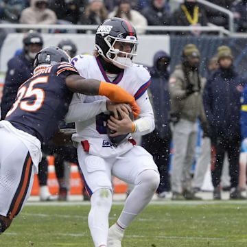 Nov 9, 2025; Chicago, Illinois, USA; Chicago Bears safety C.J. Gardner-Johnson (35) sacks New York Giants quarterback Jaxson Dart (6) during the first half at Soldier Field.  
