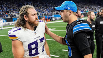 Detroit Lions quarterback Jared Goff (16), right, talks to Minnesota Vikings tight end T.J. Hockenson (87).