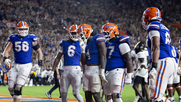 Oct 5, 2024; Gainesville, Florida, USA; Florida Gators running back Montrell Johnson Jr. (1) celebrates with Florida Gators offensive lineman Austin Barber (58), Florida Gators wide receiver Elijhah Badger (6), Florida Gators offensive lineman Knijeah Harris (77), and Florida Gators offensive lineman Brandon Crenshaw-Dickson (65) after scoring a touchdown against the UCF Knights during the first half at Ben Hill Griffin Stadium. Mandatory Credit: Matt Pendleton-Imagn Images Oct 5, 2024; Gainesville, Florida, USA; Florida Gators running back Montrell Johnson Jr. (1) celebrates with Florida Gators offensive lineman Austin Barber (58), Florida Gators wide receiver Elijhah Badger (6), Florida Gators offensive lineman Knijeah Harris (77), and Florida Gators offensive lineman Brandon Crenshaw-Dickson (65) after scoring a touchdown against the UCF Knights during the first half at Ben Hill Griffin Stadium. Mandatory Credit: Matt Pendleton-Imagn Images