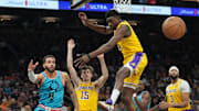 Nov 22, 2022; Phoenix, Arizona, USA; Phoenix Suns guard Duane Washington Jr. (4) passes the ball by Los Angeles Lakers forward Troy Brown Jr. (7) by during the second half at Footprint Center. Mandatory Credit: Joe Camporeale-Imagn Images