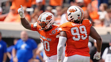 Oklahoma State's Collin Oliver (30) and Iman Oates (99) celebrate a play in the second half of the college football game between the Oklahoma State Cowboys and South Dakota State Jackrabbits at Boone Pickens Stadium in Stillwater, Okla., Saturday, Aug., 31, 2024.