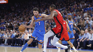 Oct 21, 2025; Oklahoma City, Oklahoma, USA; Oklahoma City Thunder center Chet Holmgren (7) moves the ball down the court as Houston Rockets forward Kevin Durant (7) defends during the first half at Paycom Center. Mandatory Credit: Alonzo Adams-Imagn Images