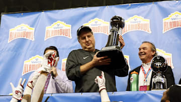 Dec 28, 2018; San Antonio, TX, United States; Washington State Cougars head coach Mike Leach holds up the Champions trophy after the Valero Alamo Bowl game between the Iowa State Cyclones and the Washington State Cougars at Alamodome. Mandatory Credit: Soobum Im-Imagn Images