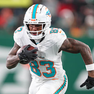 Miami Dolphins wide receiver Malik Washington (83) gains yards after catch during the first half against the New York Jets at MetLife Stadium.