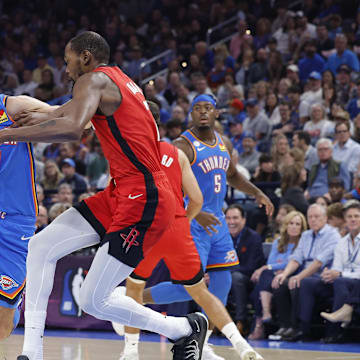Oct 21, 2025; Oklahoma City, Oklahoma, USA; Oklahoma City Thunder center Chet Holmgren (7) moves the ball down the court as Houston Rockets forward Kevin Durant (7) defends during the first half at Paycom Center. Mandatory Credit: Alonzo Adams-Imagn Images