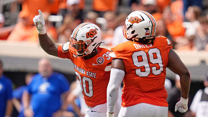 Oklahoma State's Collin Oliver (30) and Iman Oates (99) celebrate a play in the second half of the college football game between the Oklahoma State Cowboys and South Dakota State Jackrabbits at Boone Pickens Stadium in Stillwater, Okla., Saturday, Aug., 31, 2024.