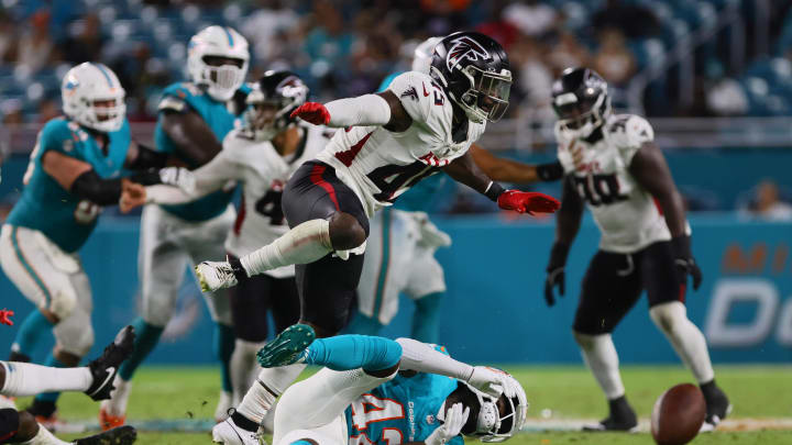 Atlanta Falcons linebacker Donavan Mutin breaks up a pass intended for Miami Dolphins wide receiver Je'Quan Burton.