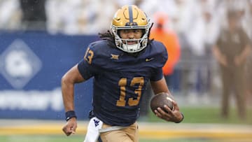 Sep 27, 2025; Morgantown, West Virginia, USA; West Virginia Mountaineers quarterback Jaylen Henderson (13) runs the ball during the first quarter against the Utah Utes at Milan Puskar Stadium. Mandatory Credit: Ben Queen-Imagn Images