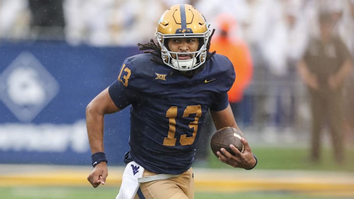 Sep 27, 2025; Morgantown, West Virginia, USA; West Virginia Mountaineers quarterback Jaylen Henderson (13) runs the ball during the first quarter against the Utah Utes at Milan Puskar Stadium. Mandatory Credit: Ben Queen-Imagn Images