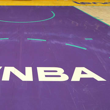 The WNBA logo on the court at Crypto.com Arena.