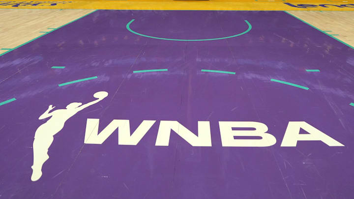 The WNBA logo on the court at Crypto.com Arena.