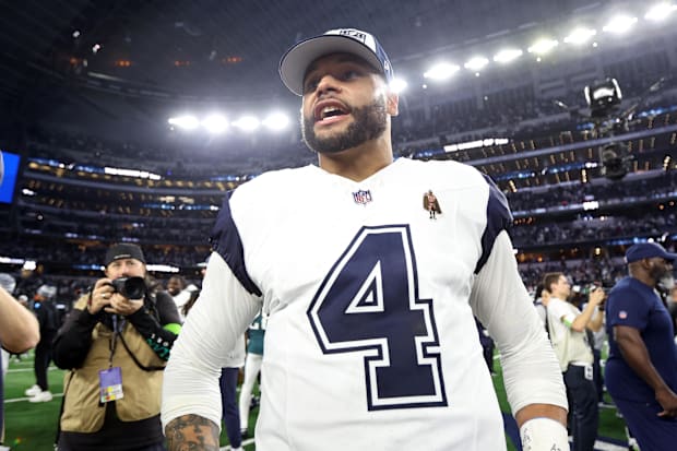 Dallas Cowboys Quarterback Dak Prescott smiles on the field after the game against the Philadelphia Eagles.