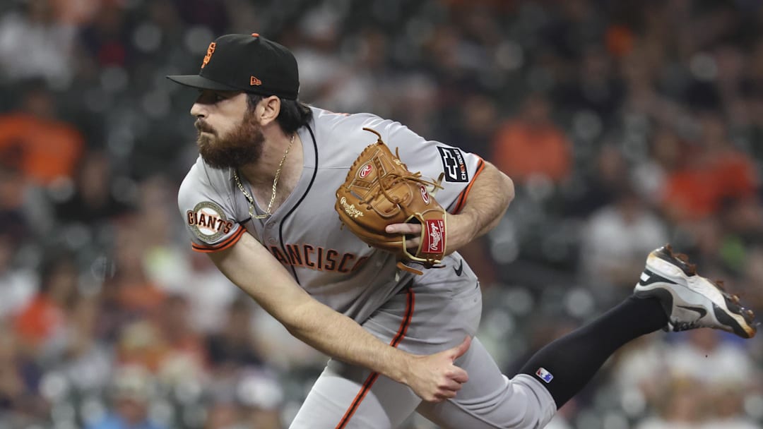 Apr 1, 2025; Houston, Texas, USA; San Francisco Giants relief pitcher Ryan Walker (74) delivers a pitch during the ninth inning against the Houston Astros at Daikin Park. Mandatory Credit: Troy Taormina-Imagn Images