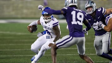 Oct 26, 2024; Manhattan, Kansas, USA; Kansas Jayhawks quarterback Jalon Daniels (6) looks for room to run against Kansas State Wildcats safety VJ Payne (19) during the second quarter at Bill Snyder Family Football Stadium. Mandatory Credit: Scott Sewell-Imagn Images