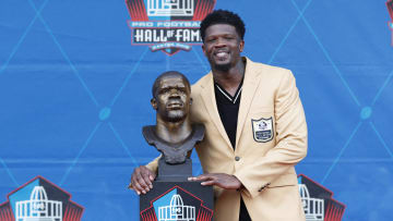 Aug 3, 2024; Canton, OH, USA;  Class of 2024 member Andre Johnson poses with his bust after his enshrinement into the Pro Football Hall of Fame at the enshrinement ceremony at Tom Benson Hall of Fame Stadium. Mandatory Credit: Charles LeClaire-USA TODAY Sports