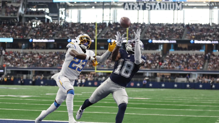 Aug 24, 2024; Arlington, Texas, USA; Dallas Cowboys wide receiver Ryan Flournoy (18) catches a touchdown pass against Los Angeles Chargers cornerback Matt Hankins (23)  in the second quarter at AT&T Stadium. 