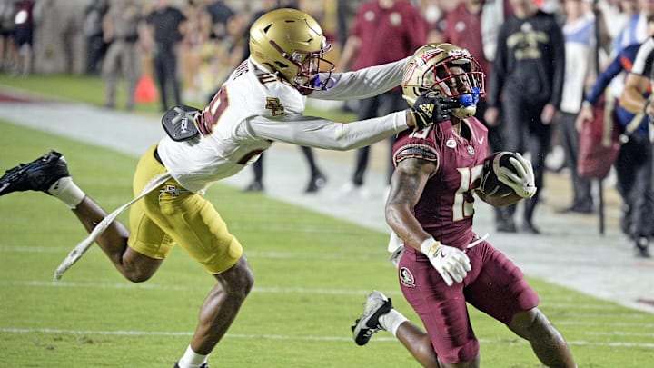 Sep 2, 2024; Tallahassee, Florida, USA; Florida State Seminoles running back Jaylin Lucas (13) is tackled by Boston College Eagles defensive back Carter Davis (28) during the first half at Doak S. Campbell Stadium. Mandatory Credit: Melina Myers-Imagn Images