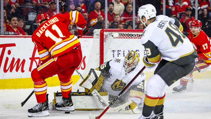 Apr 15, 2025; Calgary, Alberta, CAN; Vegas Golden Knights goaltender Ilya Samsonov (35) makes a save against Calgary Flames center Mikael Backlund (11) during the overtime period at Scotiabank Saddledome. Mandatory Credit: Sergei Belski-Imagn Images