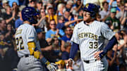 Sep 28, 2025; Milwaukee, Wisconsin, USA; Milwaukee Brewers catcher Danny Jansen (33) is greeted by  designated hitter Christian Yelich (22) after hitting a 2-run homer in the fourth inning against the Cincinnati Reds at American Family Field. Mandatory Credit: Benny Sieu-Imagn Images