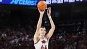 Feb 8, 2025; Fayetteville, Arkansas, USA; Arkansas Razorbacks forward Zvonimir Ivisic (44) shoots a three point shot in the first half as Alabama Crimson Tide forward Grant Nelson (4) defends at Bud Walton Arena. Mandatory Credit: Nelson Chenault-Imagn Images