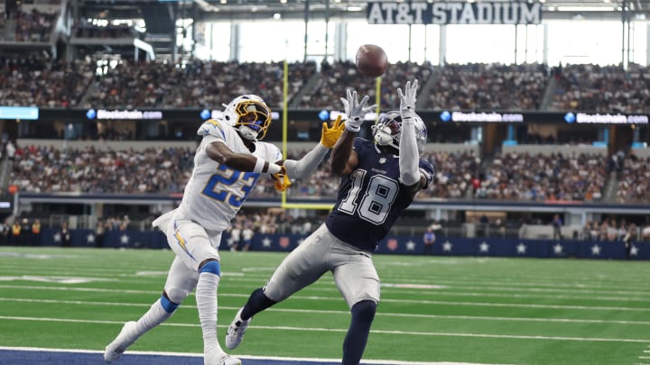 Aug 24, 2024; Arlington, Texas, USA; Dallas Cowboys wide receiver Ryan Flournoy (18) catches a touchdown pass against Los Angeles Chargers cornerback Matt Hankins (23)  in the second quarter at AT&T Stadium. 