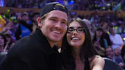 Oct 24, 2025; Los Angeles, California, USA; Los Angeles Chargers quarterback Justin Herbert (left) and girlfriend Madison Beer attend the game between the Minnesota Timberwolves and the Los Angeles Lakers at Crypto.com Arena. Mandatory Credit: Kirby Lee-Imagn Images