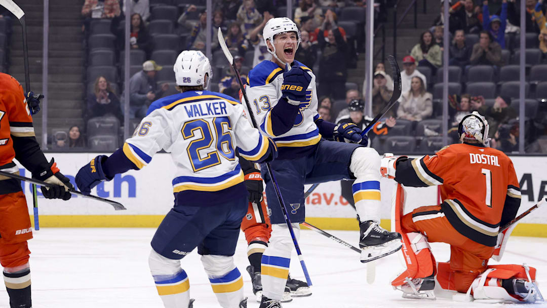 Mar 7, 2025; Anaheim, California, USA;  St. Louis Blues right wing Alexey Toropchenko (13) celebrates scoring with left wing Nathan Walker (26) as Anaheim Ducks goaltender Lukas Dostal (1) reacts during the first period at Honda Center. Mandatory Credit: Ryan Sun-Imagn Images