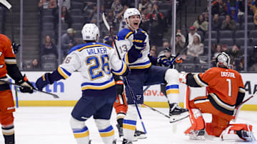 Mar 7, 2025; Anaheim, California, USA;  St. Louis Blues right wing Alexey Toropchenko (13) celebrates scoring with left wing Nathan Walker (26) as Anaheim Ducks goaltender Lukas Dostal (1) reacts during the first period at Honda Center. Mandatory Credit: Ryan Sun-Imagn Images