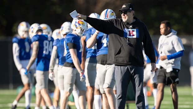 Kansas assistant head coach and offensive coordinator Jeff Grimes directs players during an outdoor practice Thursday, April 