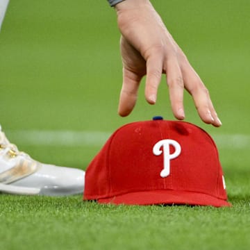 Apr 11, 2025; St. Louis, Missouri, USA;  Philadelphia Phillies third baseman Alec Bohm (28) picks up his hat after chasing down a fly ball against the St. Louis Cardinals during the third inning at Busch Stadium. Mandatory Credit: Jeff Curry-Imagn Images