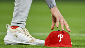 Apr 11, 2025; St. Louis, Missouri, USA;  Philadelphia Phillies third baseman Alec Bohm (28) picks up his hat after chasing down a fly ball against the St. Louis Cardinals during the third inning at Busch Stadium. Mandatory Credit: Jeff Curry-Imagn Images