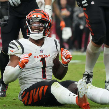 Cincinnati Bengals receiver Ja'Marr Chase (1) smiles from the ground after a first-down reception against the Arizona Cardinals at State Farm Stadium in Glendale on Oct. 8, 2023.