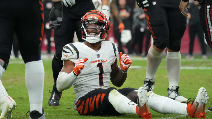 Cincinnati Bengals receiver Ja'Marr Chase (1) smiles from the ground after a first-down reception against the Arizona Cardinals at State Farm Stadium in Glendale on Oct. 8, 2023.