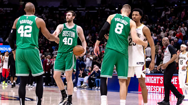 Jan 31, 2025; New Orleans, Louisiana, USA;  New Orleans Pelicans guard Trey Murphy III (25) hugs Boston Celtics center Kristaps Porzingis (8) after the game at Smoothie King Center. Mandatory Credit: Stephen Lew-Imagn Images